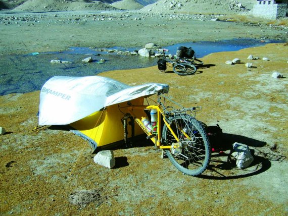 Topeak's camping solution makes the bike part of the tent. Topeak's camping solution makes the bike part of the tent.